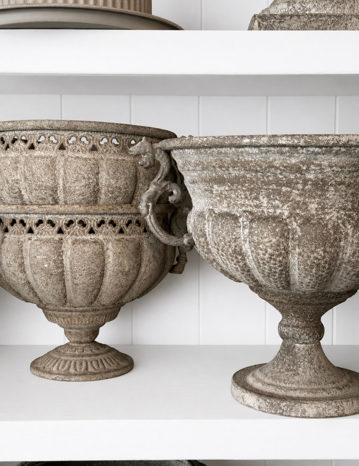 Aged patina metal urns styled on shelf - HAROLDS