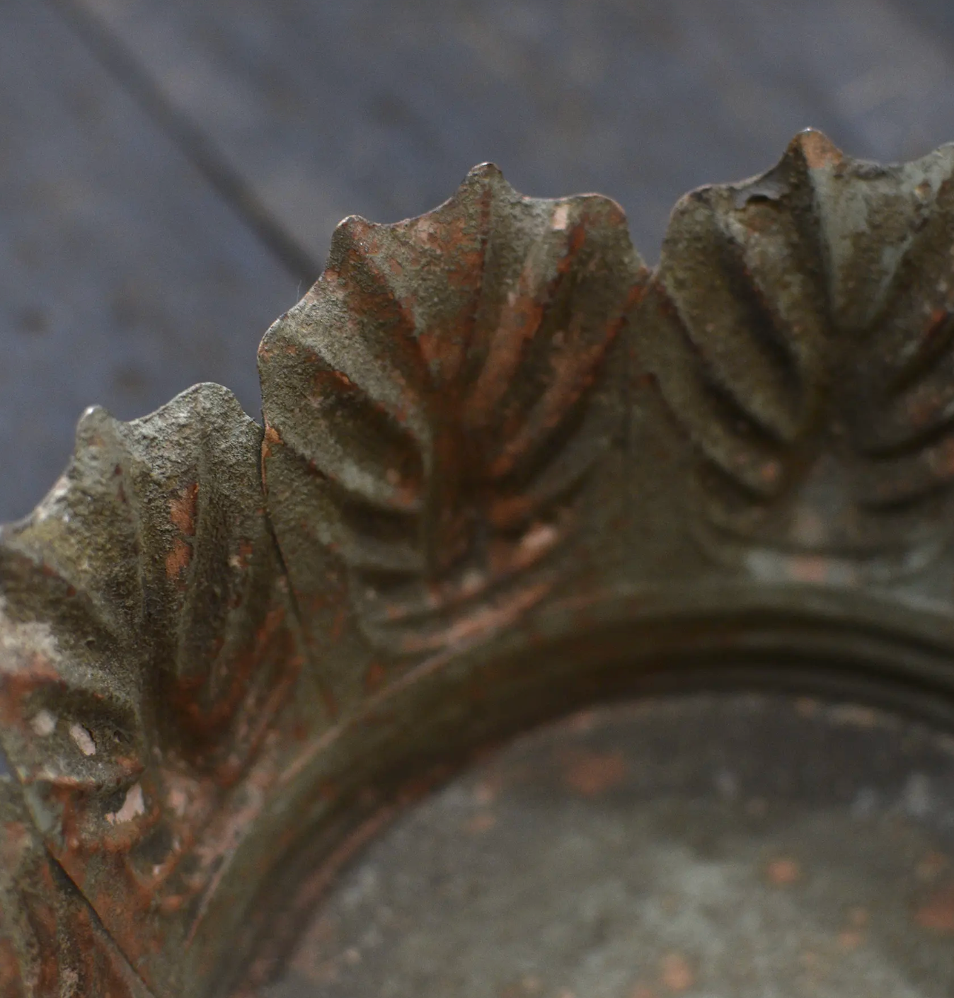 Close detail of Carla Fluted Bowl decorative leaf rim and fluted body in aged patina