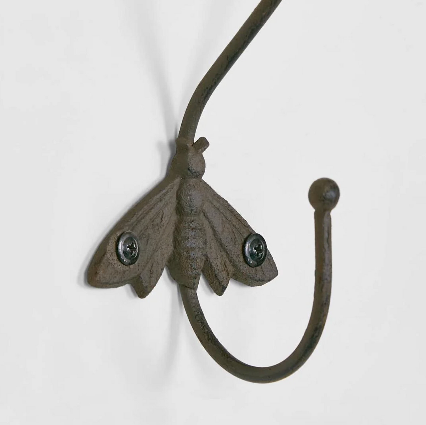 Cast Iron Bee Wall Hook in aged brown - close up detail of bee motif and wall mount screws