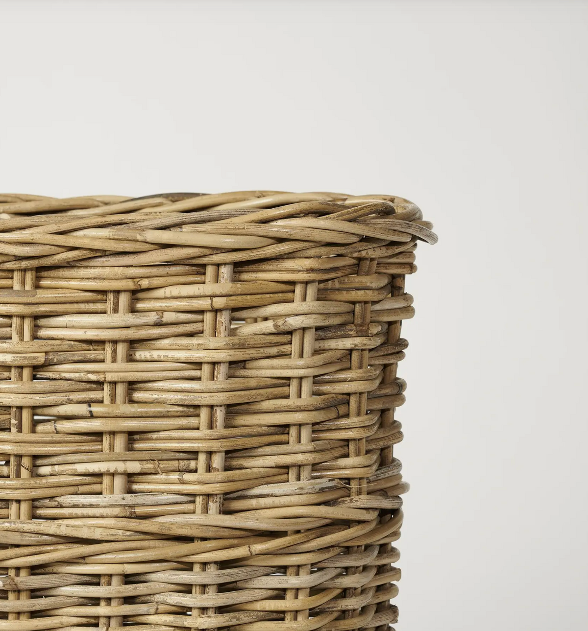 Front view of oval woven umbrella stand showing triple-weave bands