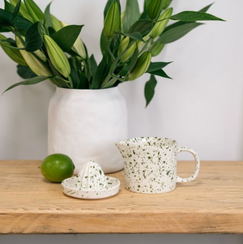 Removable ridged reamer lifted from green speckled juicer jug