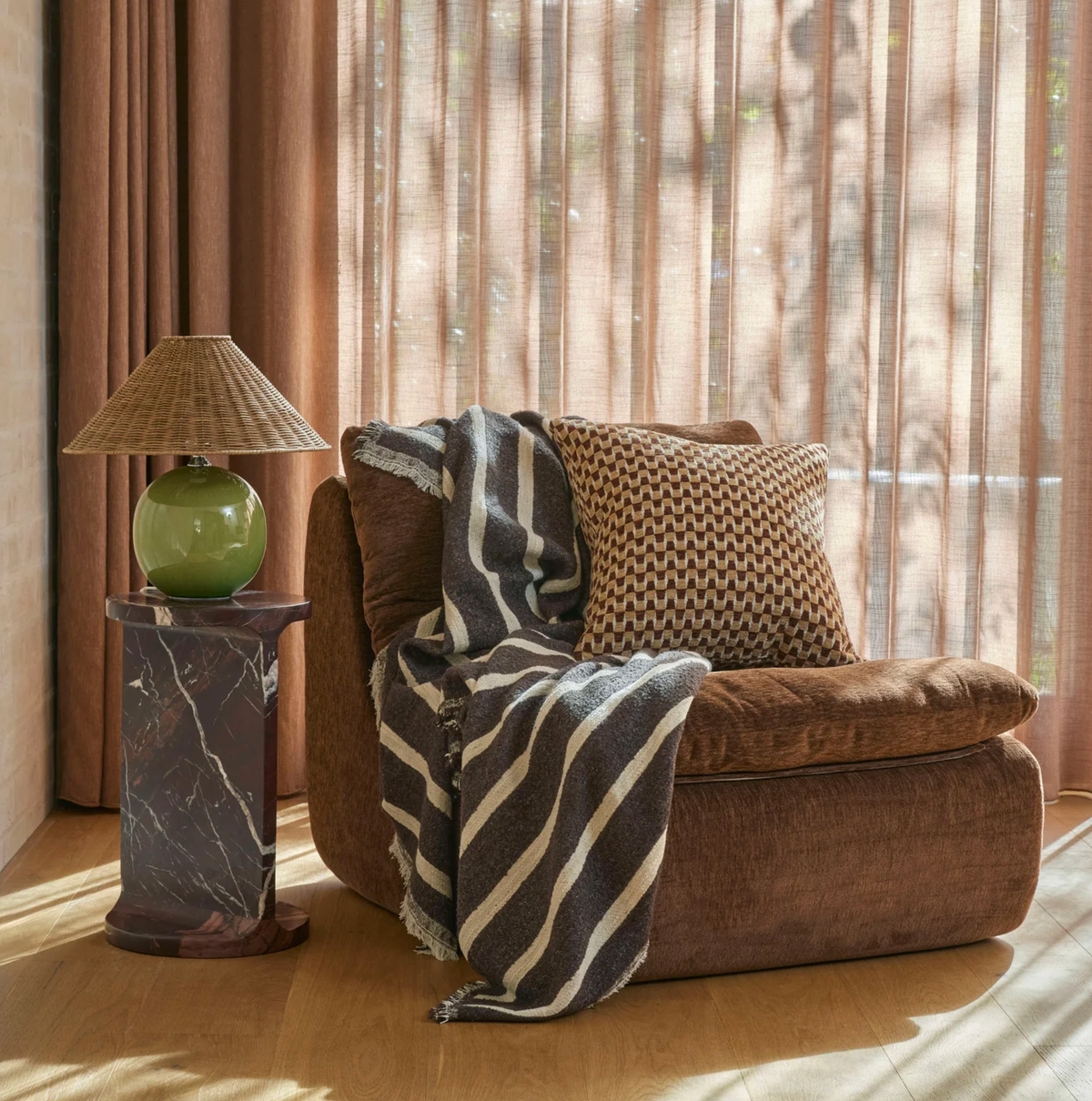 Brown throw with natural horizontal stripes and fringed edges shown flat