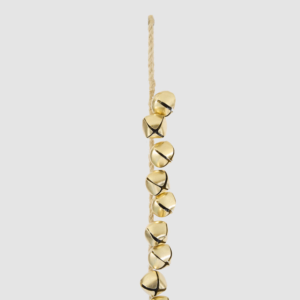 Close-up of gold bells attached along the garland cord