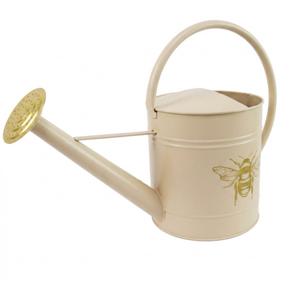 Sand bee watering can displayed outdoors beside a potted plant