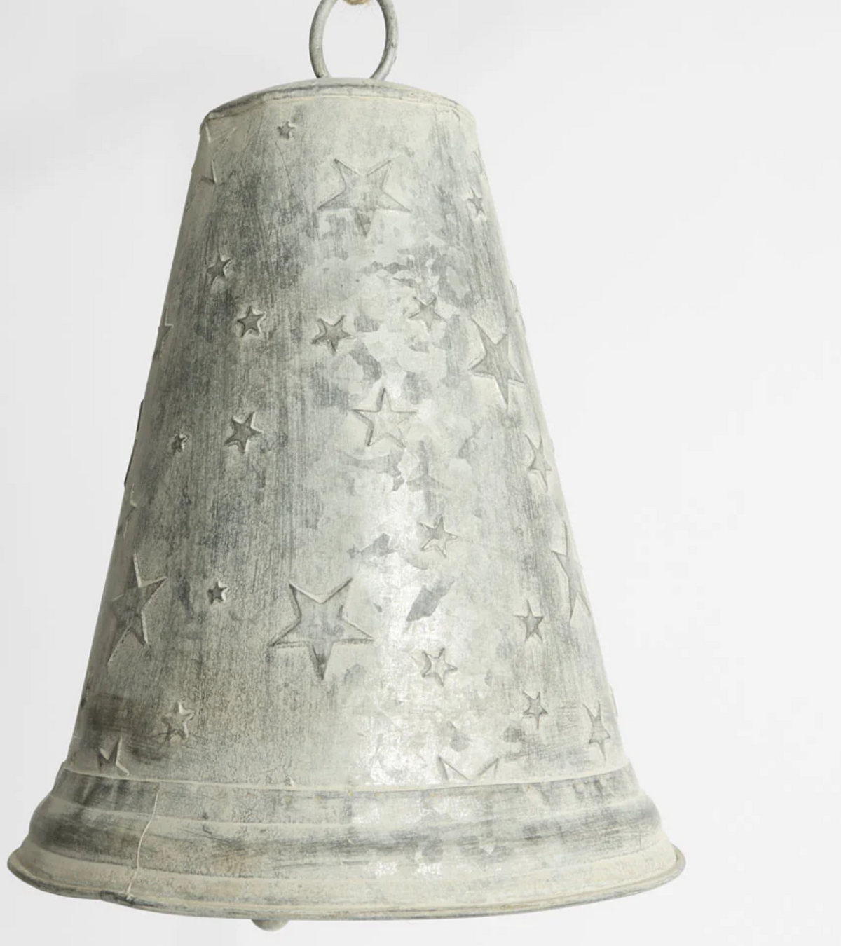 Close-up of large zinc bell with scattered star detailing