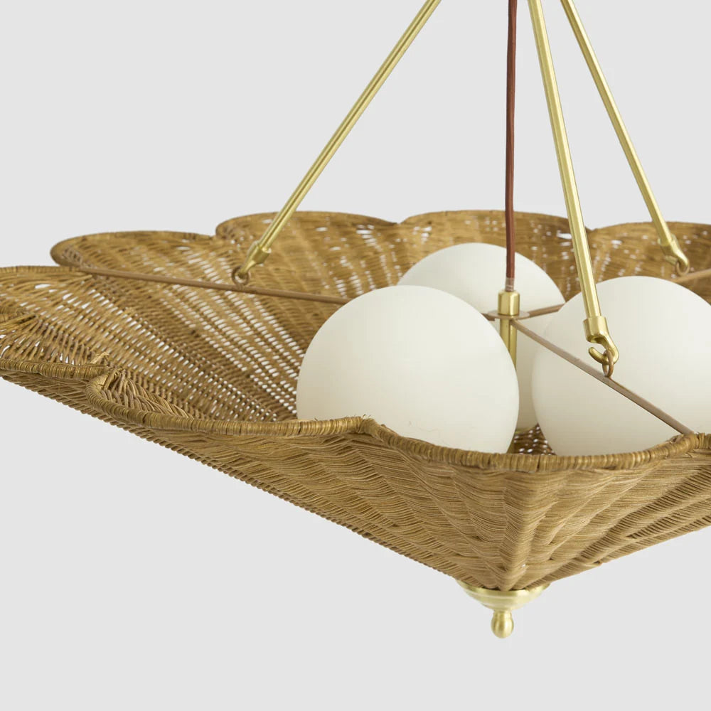Illuminated frosted glass diffusers inside the scalloped rattan ceiling pendant