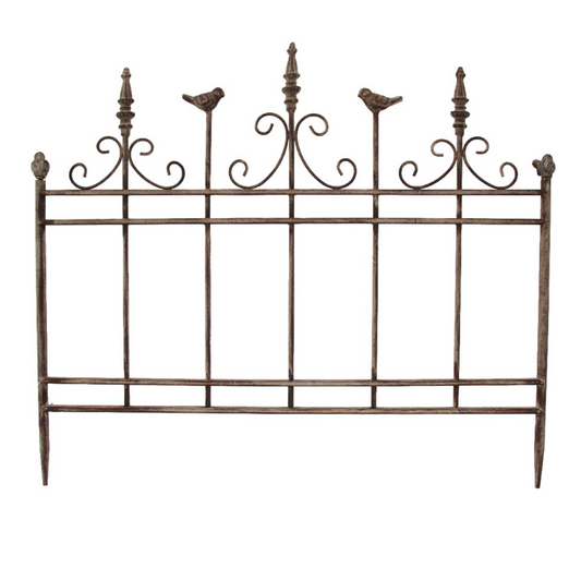 Decorative iron garden panel with ornate scrollwork, finial posts and perched bird details, aged brown finish