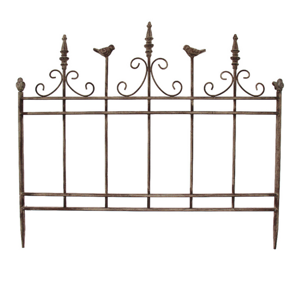 Decorative iron garden panel with ornate scrollwork, finial posts and perched bird details, aged brown finish