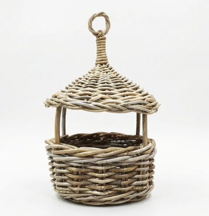 A small decorative wicker basket with a pointed roof and hanging loop, shown on a plain white studio background.