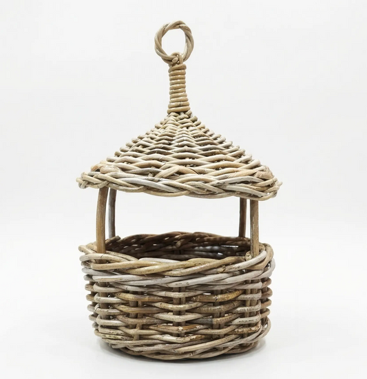 A small decorative wicker basket with a pointed roof and hanging loop, shown on a plain white studio background.