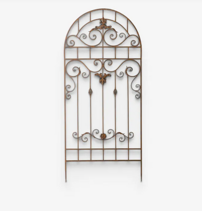An ornate wrought iron gate screen with an arched top and decorative scrollwork, shown against a plain white background.