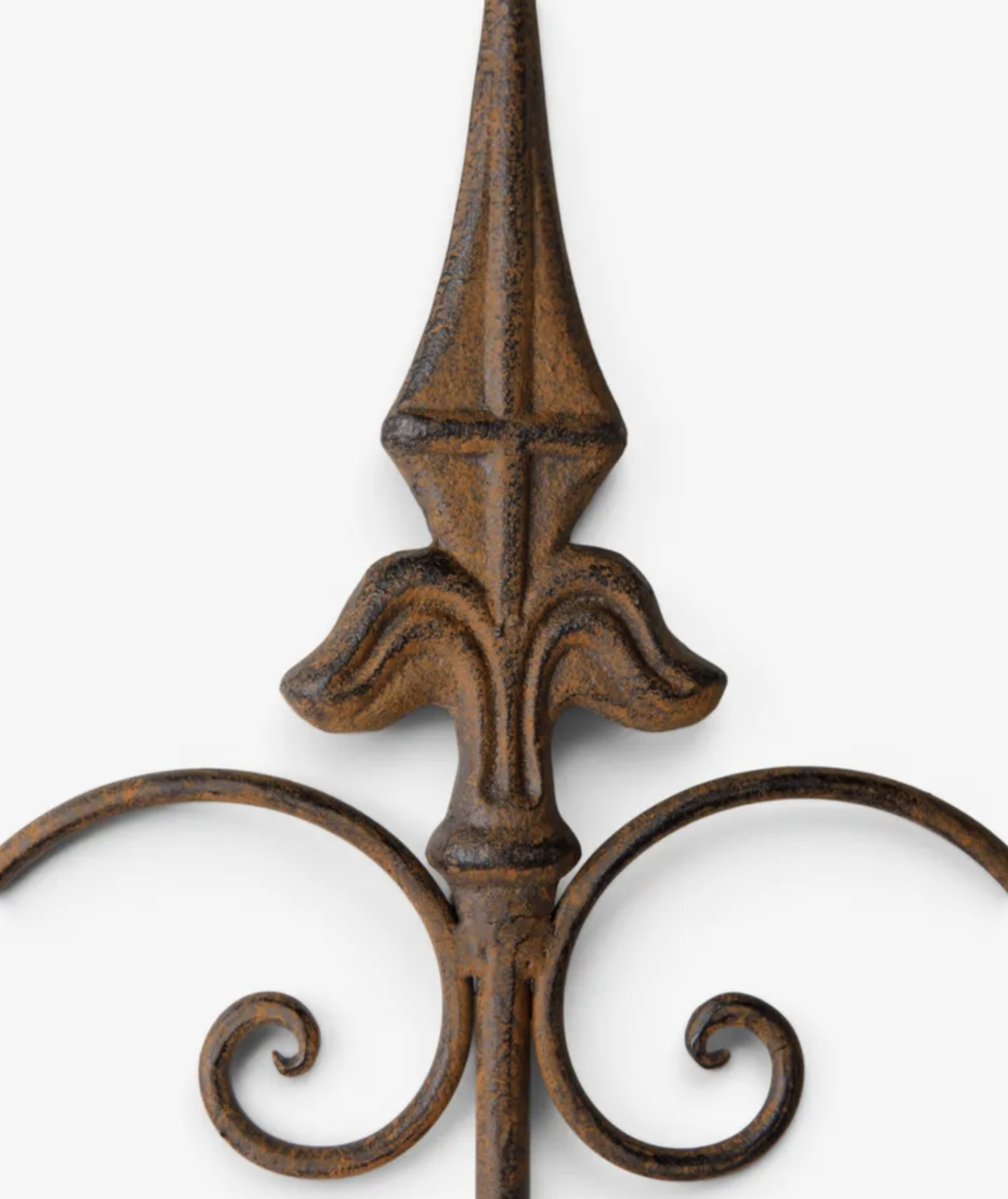 Close-up of a decorative wrought iron fence post with a textured, distressed brown finish and ornate scrollwork at the base, set against a plain light gray background.