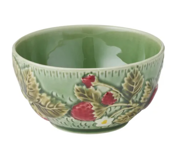 A green ceramic bowl decorated with embossed strawberry leaves and red strawberries, shown against a plain white background.