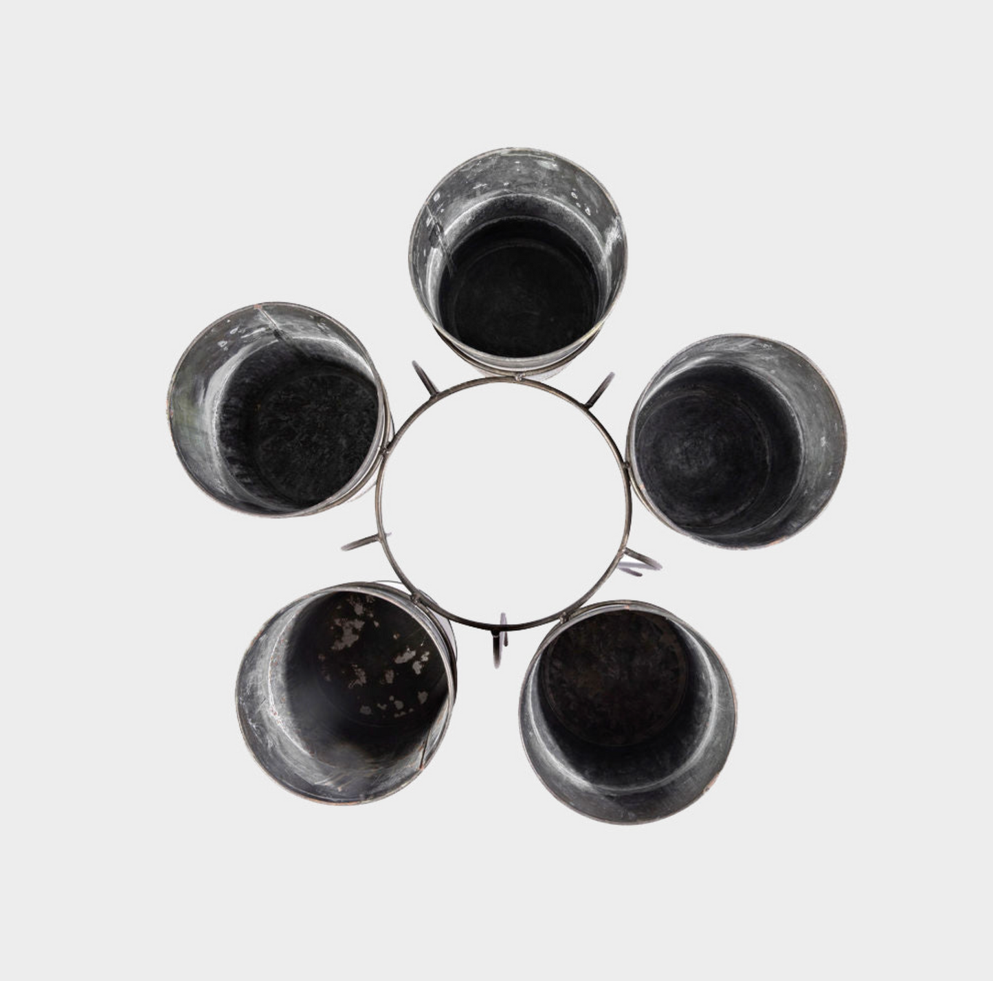 Five dark, used plastic cups arranged in a circular pattern on a light gray background.