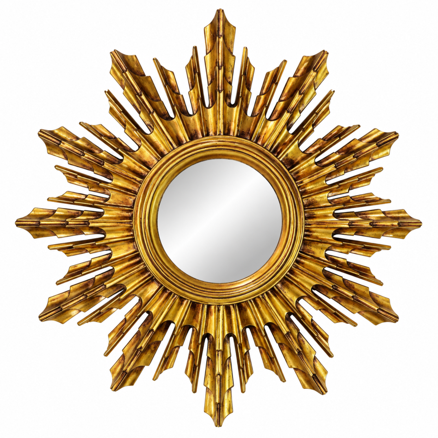 A round wall mirror with an ornate, sculptural sunburst frame in a metallic gold finish, isolated on a white background.