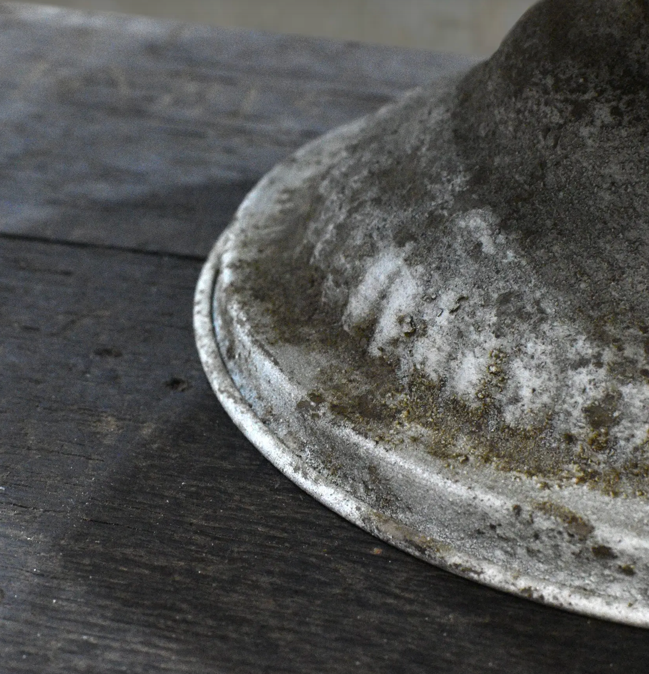 Close detail of Aria Footed Bowl base showing aged patina and embossed scrollwork