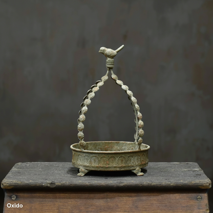 Avilia Bird Planter in Blanca finish showing full height with arched beaded handle and bird finial