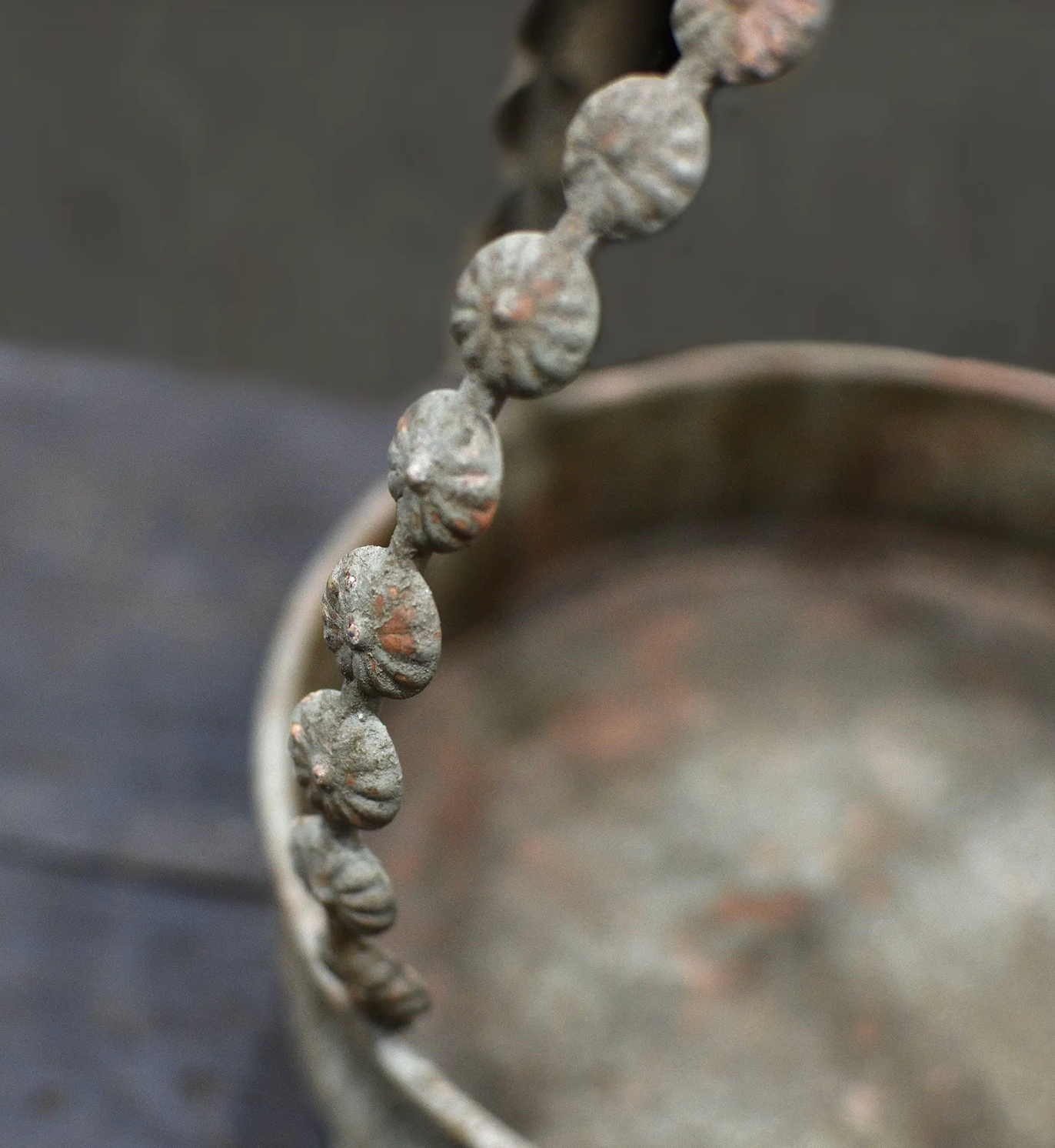 Close detail of beaded stem and arched handle on the Avilia Bird Planter