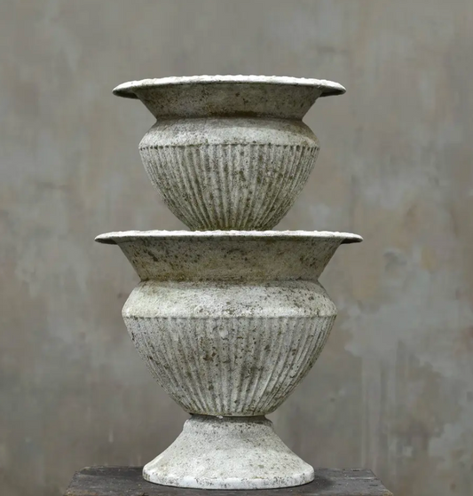 Two fluted urns in Blanca finish stacked showing Medium and Large size comparison