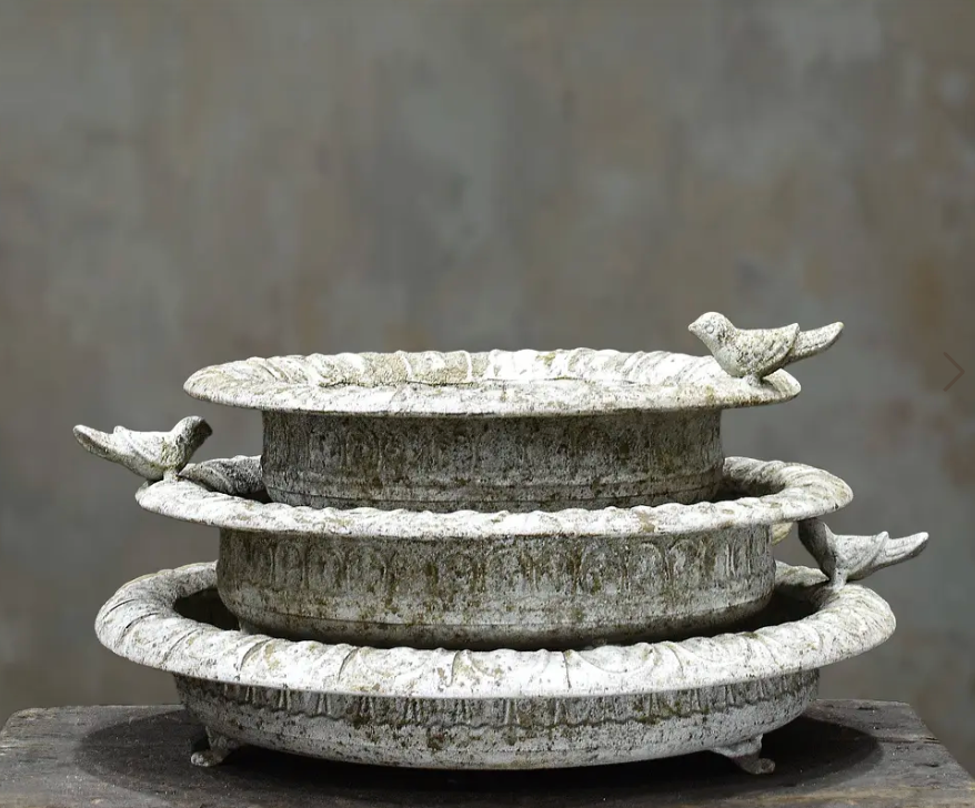 Shallow cast iron bird dish in aged Blanca patina with perched bird on rim and small iron feet