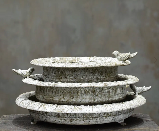 Shallow cast iron bird dish in aged Blanca patina with perched bird on rim and small iron feet