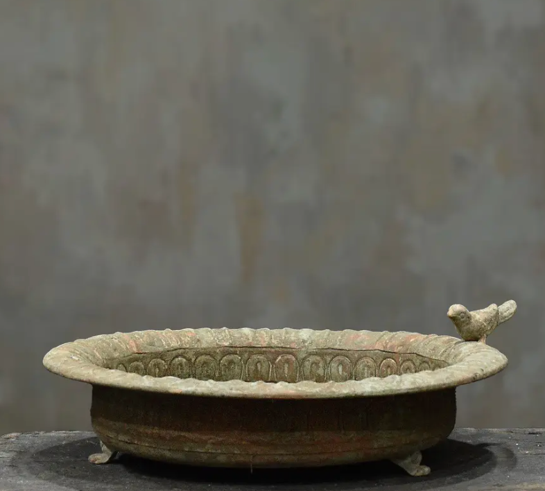 Three cast iron bird dishes stacked showing Small, Medium and Large size progression