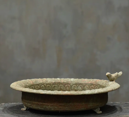 Three cast iron bird dishes stacked showing Small, Medium and Large size progression