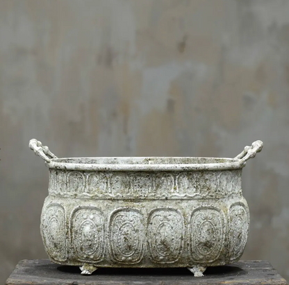 Embossed metal trough planter in aged Blanca patina with foliate panels, side handles and claw feet