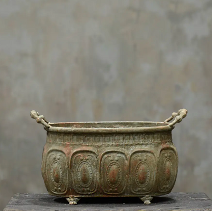 Embossed trough planter in Oxido finish - side view showing claw feet and embossed body detail