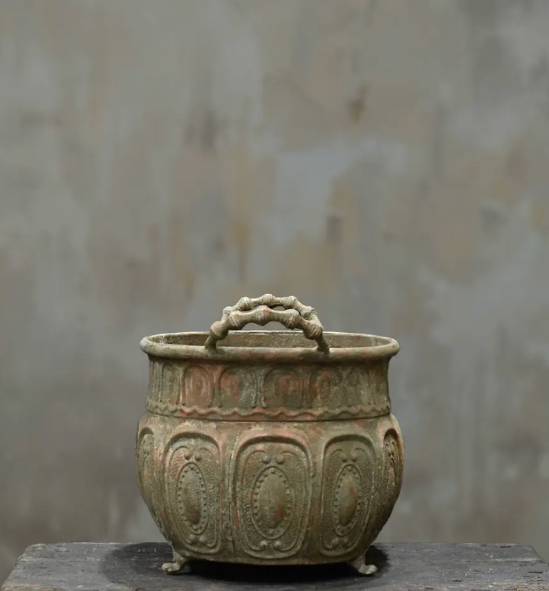 Close detail of twisted side handle and beaded rim on embossed trough planter in aged Blanca patina