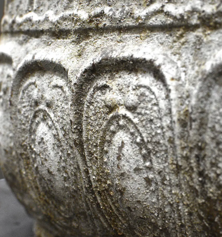 Close detail of embossed body texture and weathered patina on trough planter
