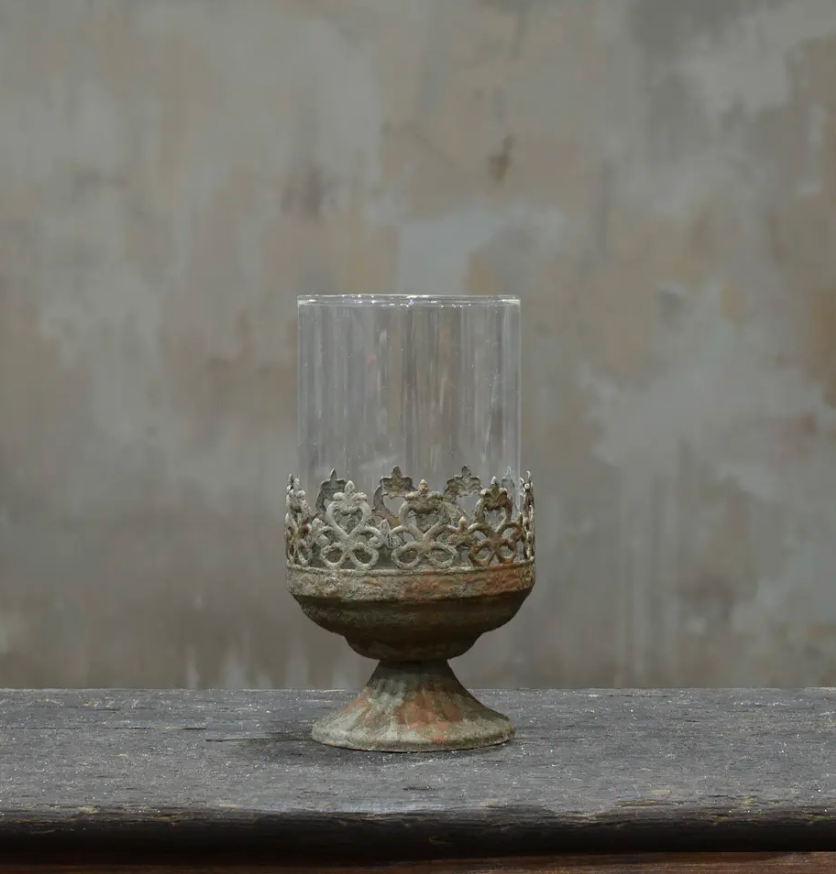 Small footed metal crown candle holder in aged Oxido patina showing darker weathered finish