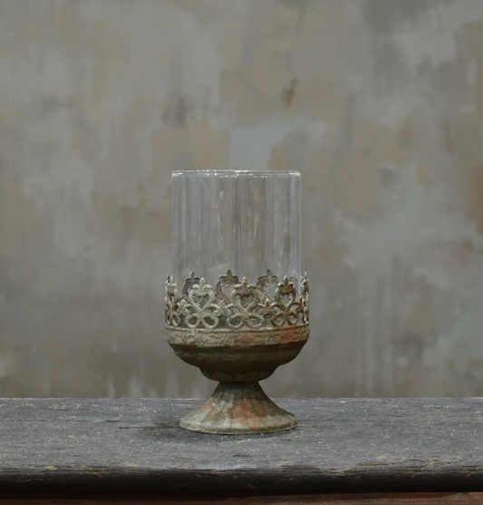 Small footed metal crown candle holder in aged Oxido patina showing darker weathered finish