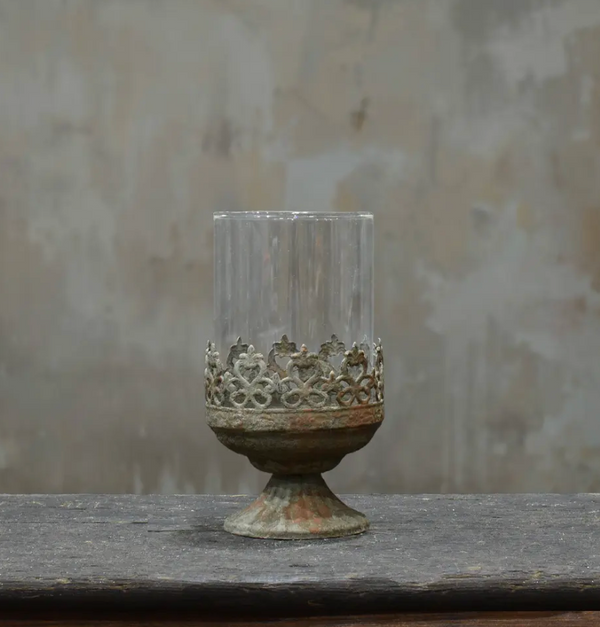 Small footed metal crown candle holder in aged Oxido patina showing darker weathered finish
