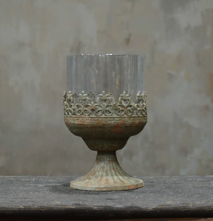 Large footed metal crown candle holder in aged Oxido patina with glass hurricane insert