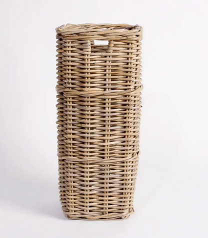 Tall square Kubu cane umbrella stand held by person showing scale - natural woven rattan with cut-out handles