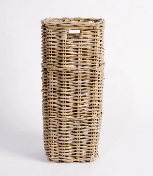 Tall square Kubu cane umbrella stand held by person showing scale - natural woven rattan with cut-out handles