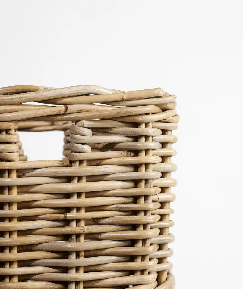 Close detail of open weave body and cut-out handle on Kubu cane umbrella stand - darker natural tone