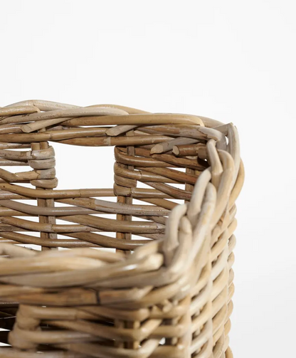 Close detail of rim and cut-out handle on Kubu cane umbrella stand showing natural cane texture