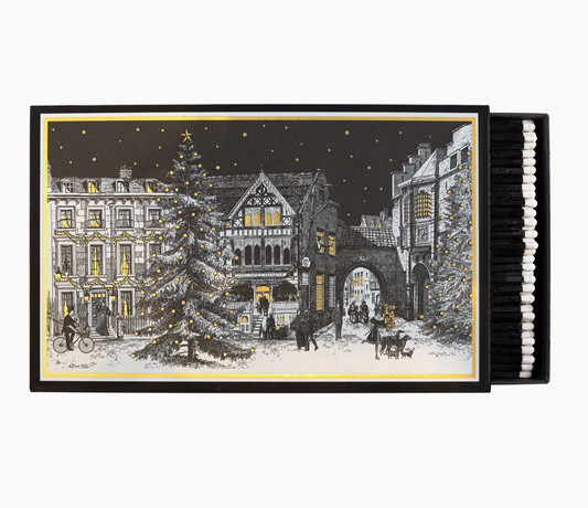 Starry Night giant matchbox open showing 150 black-tipped white matchsticks and illustrated Victorian Christmas town square with decorated tree and gold stars