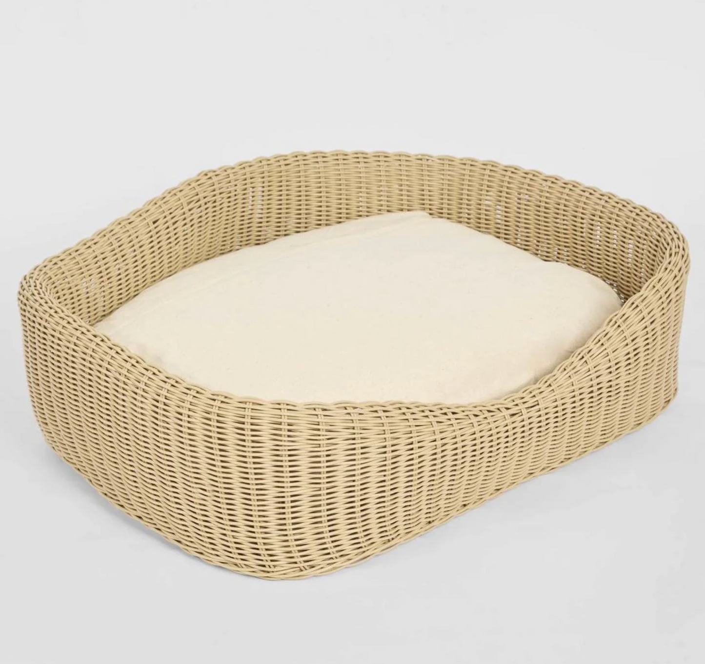 Rattan Pet Bed overhead angle showing open form and cream cushion