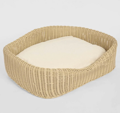 Rattan Pet Bed overhead angle showing open form and cream cushion