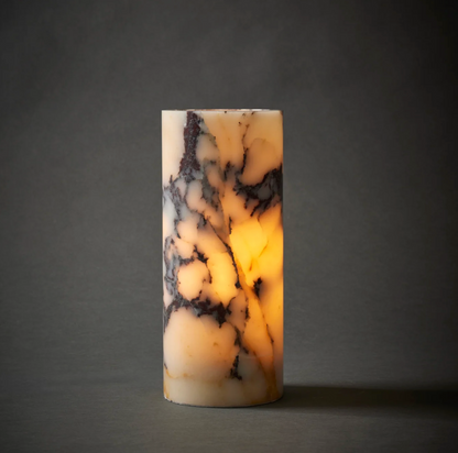 Marble effect table lamp lit, warm glow visible through the stone-effect shade