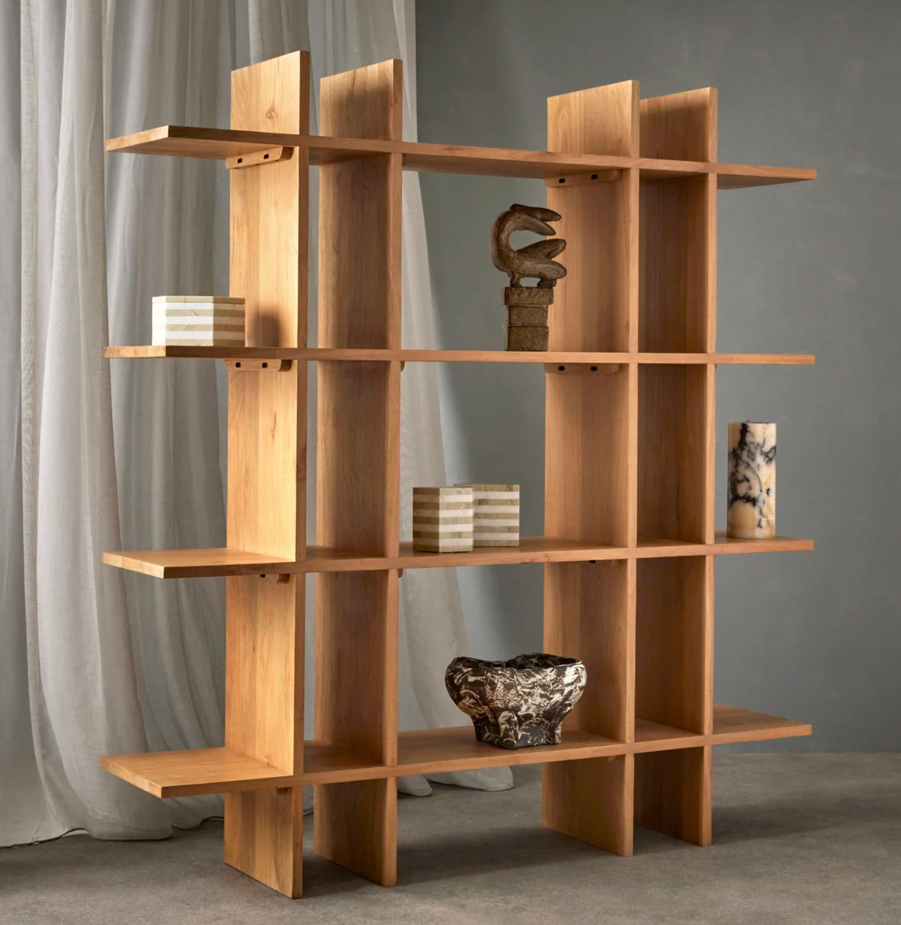 Marble effect table lamp styled on a timber shelving unit with decorative objects