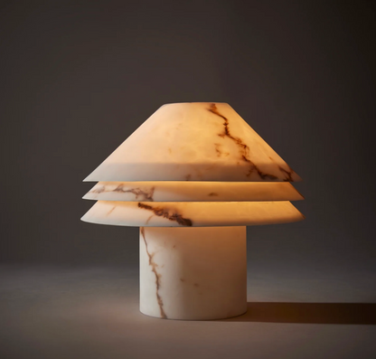 Faux alabaster tiered table lamp unlit, showing ivory tone and natural veining