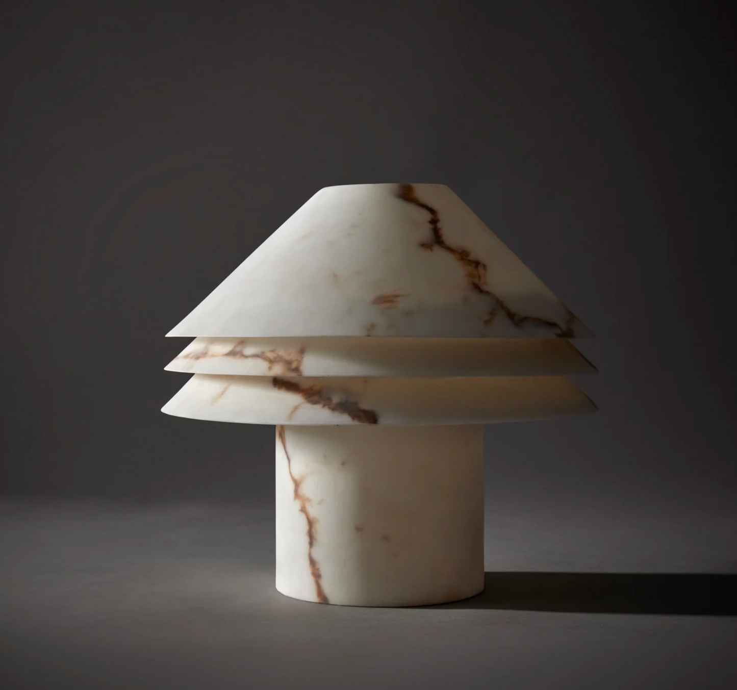 Faux alabaster tiered table lamp on white background showing full form