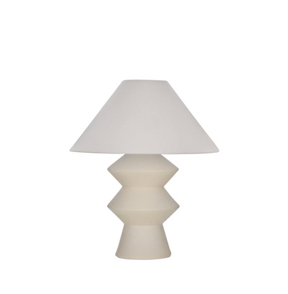 White geometric fiberglass table lamp with linen shade on white background