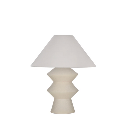 White geometric fiberglass table lamp with linen shade on white background