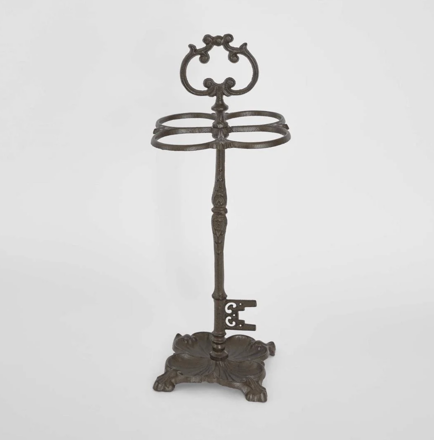 Cast Iron Umbrella Stand in dark aged finish - front view showing scrolled crest and four oval rings