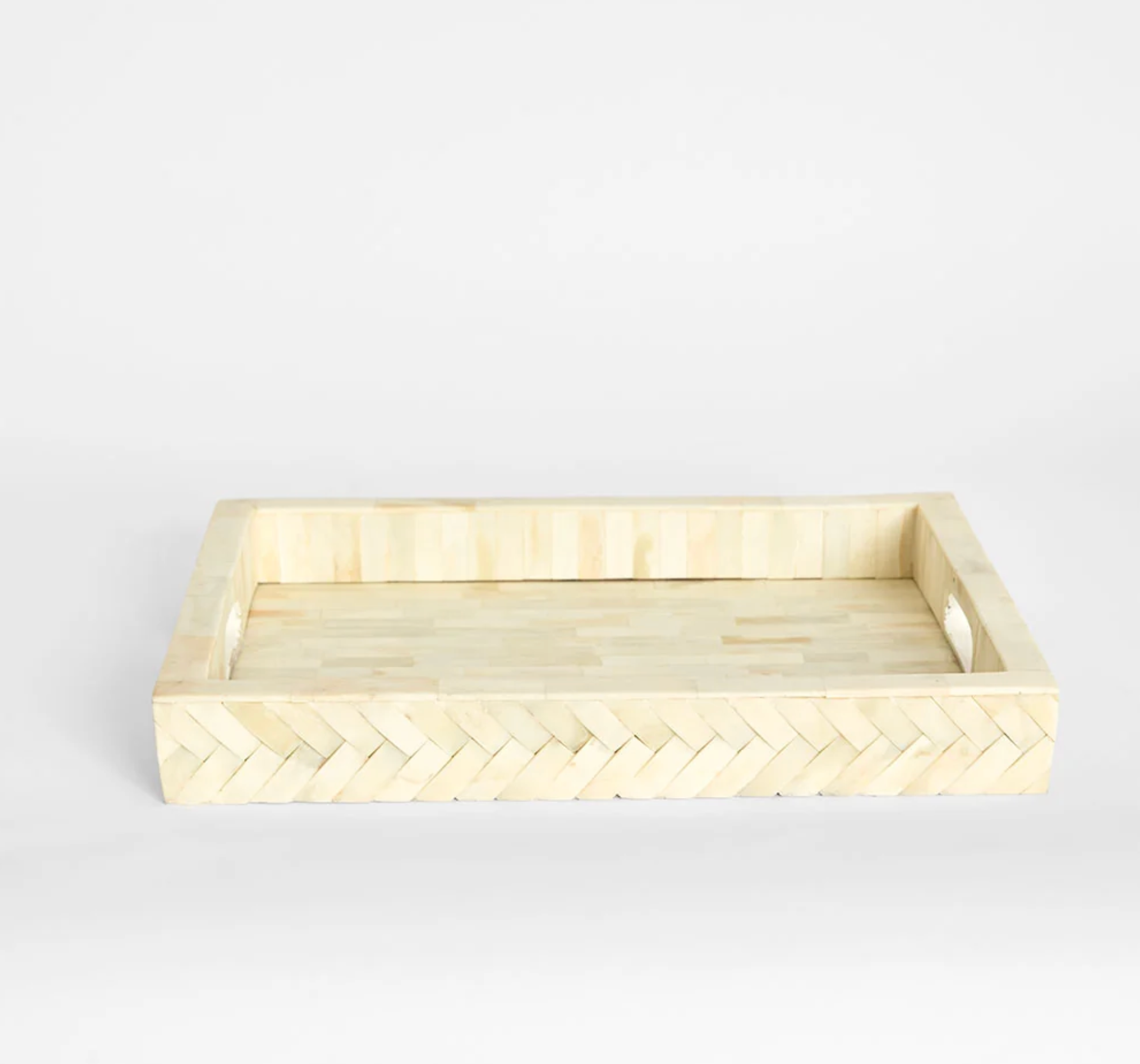 Bone inlay tray styled on dining table with decorative objects